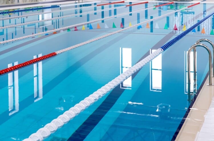Swimming pool with marked red and white lanes.