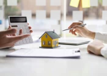 Businessmen, real estate agents discuss house purchase prices, fee, mortgage, interest, rent, cash flow, loan. Negotiate for businessmen to legally sign home purchase agreements contract , lease.