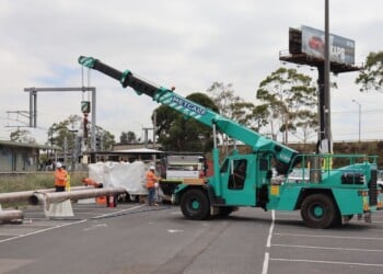 Crane lifting jet fuel pipes on site at Albion Station